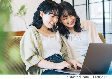 Female friends looking at a computer together 132034150