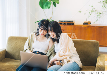 Female friends looking at a computer together 132034152