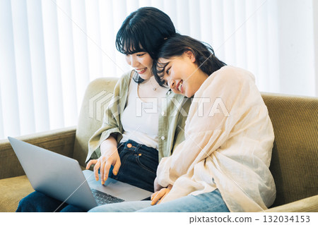 Female friends looking at a computer together 132034153