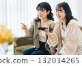 Female friends watching TV 132034265