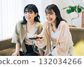 Female friends watching TV 132034266