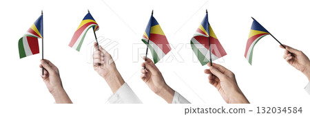 The Seychelles flag in hand in different angles on a white background The Seychelles flag in hand in different angles on a white background 132034584