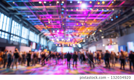 Large event crowd, diverse people, colorful lights, indoor venue, blurred background 132034920