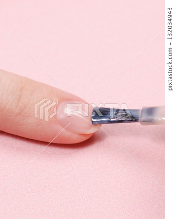 manicure in a beauty salon or at home, a woman paints her nails. manicure in a beauty salon or at home, a woman paints her nails. 132034943