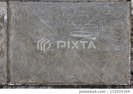 Worn concrete wall with scratches in urban outdoor setting Worn concrete wall with scratches in urban outdoor setting 132035264