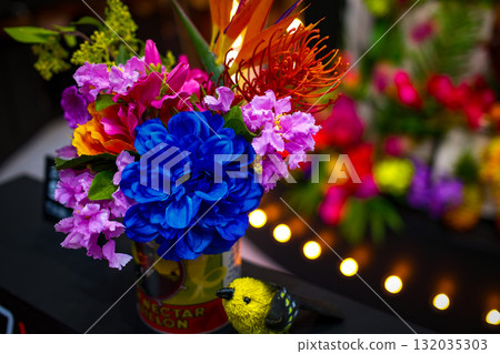 Blue flower bouquet and yellow bird figurine Blue flower bouquet and yellow bird figurine 132035303