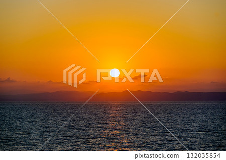 Beautiful orange sunrise sky over the sea horizon. Summer golden hour. 132035854