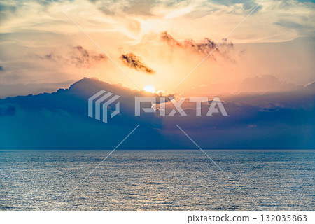 Beautiful orange sunrise sky over the sea horizon. Summer golden hour. 132035863