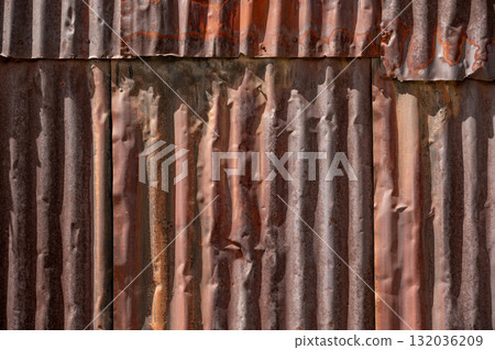 Old rusty zinc panel wall texture. Weathered galvanized steel sheet fence 132036209