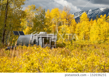Travel trailer parking among yellow bushes and aspen trees during fall foliage in Colorado, USA Travel trailer parking among yellow bushes and aspen trees during fall foliage in Colorado, USA 132036231