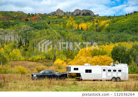 Pickup truck and travel trailer parking among colorful fall foliage of Kebler pass, Colorado, USA 132036264
