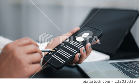 Businesswoman using smartphone for task management and productivity app at office desk 132036339
