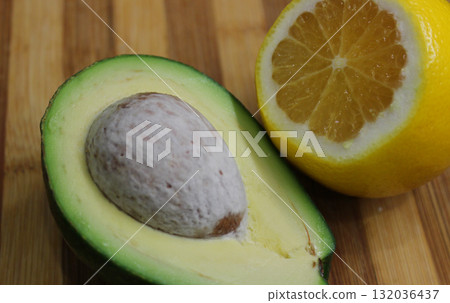 Ingredients for Healthy Food Recipes. Cutted Lemon and Avocado with Pin Inside 132036437