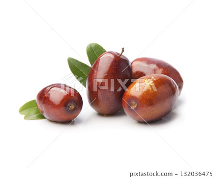 Dates fruits with leaves on white backgrounds Dates fruits with leaves on white backgrounds 132036475