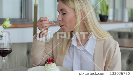 Woman eats dessert in a restaurant. Lifestyle, love, relationships concept. Customer service. Woman eats dessert in a restaurant. Lifestyle, love, relationships concept. Customer service. 132036780