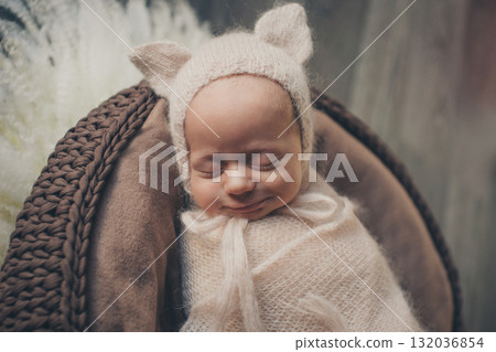 A newborn baby is wrapped in diapers with a wool cap in a basket. Swaddling, maternity hospital, family, ivf, life planning, parenting. A mother's love for her child. Baby food. High quality photo 132036854