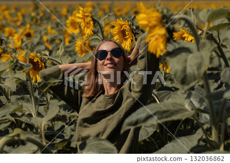 A girl in a pink skirt and a white T-shirt walks through a field of blooming yellow sunflowers. A woman dances, rejoices, smiles, enjoys life, warmth, summer, the sun. High quality FullHD footage A girl in a pink skirt and a white T-shirt walks through a field of blooming yellow sunflowers. A woman dances, rejoices, smiles, enjoys life, warmth, summer, the sun. High quality FullHD footage 132036862