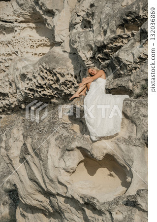 a woman in a white dress, a bride on a mountain with a blue sky. Beautiful nature, freedom, enjoyment of life. High quality photo a woman in a white dress, a bride on a mountain with a blue sky. Beautiful nature, freedom, enjoyment of life. High quality photo 132036869