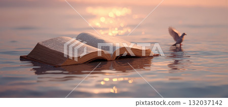 Open bible and wooden cross reflecting faith amidst calm waters at sunrise 132037142