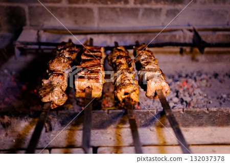 Yakitori outdoors (Japanese style chicken grill. Beef steaks on the grill with flames Yakitori outdoors (Japanese style chicken grill. Beef steaks on the grill with flames 132037378