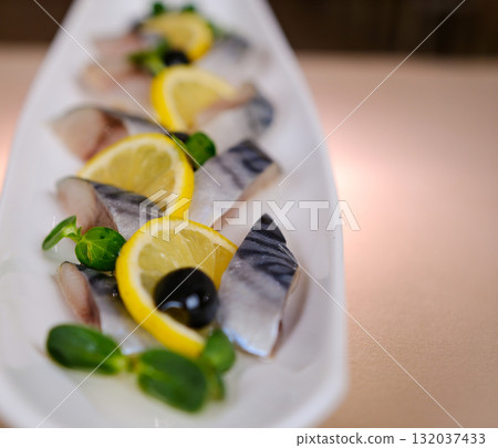 lightly salted mackerel Picture of tasty sliced lightly salted mackerel with greens and lemon at plate lightly salted mackerel Picture of tasty sliced lightly salted mackerel with greens and lemon at plate 132037433
