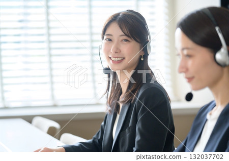 Call center woman wearing a headset in the office Call center woman wearing a headset in the office 132037702