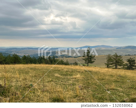 Peaceful countryside with village houses on rolling hills, natural landscape style, pine forest Peaceful countryside with village houses on rolling hills, natural landscape style, pine forest 132038062