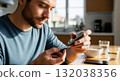 A man checking his blood sugar level with a glucometer at home. Diabetic person testing glucose from a finger prick. Health care and diabetes management concept 132038356