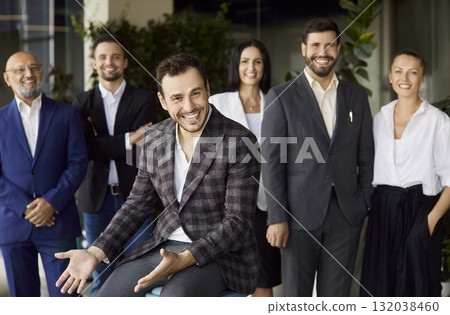 Happy business leader talking, sitting in front of smiling team on meeting Happy business leader talking, sitting in front of smiling team on meeting 132038460