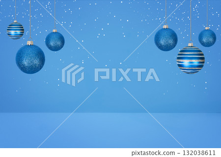 Christmas tree baubles on blue background with white snow. Festive winter holiday background. Design with copy space for greeting card, text, advertising, banner, invitation 132038611