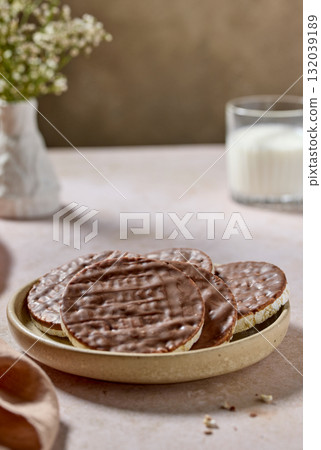 plate of rice galettes cakes cookies covered with milk chocolate 132039189