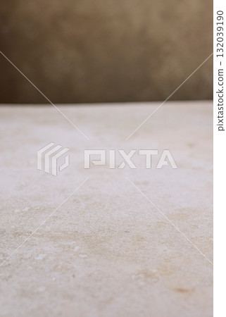 beige table and brown wall background 132039190