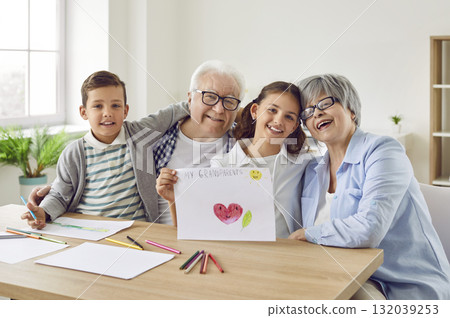 Happy grandparents and grandchildren spend time together, draw pictures and have fun Happy grandparents and grandchildren spend time together, draw pictures and have fun 132039253