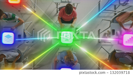 Boys and Girls Working on Desktops, Centrally Connected by Multi Colored Digital Lines Boys and Girls Working on Desktops, Centrally Connected by Multi Colored Digital Lines 132039718