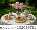 Delicious Scones and Pastries on a Garden Tea Table 132039781