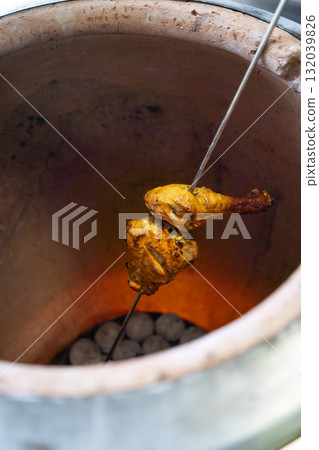 Tandoori chicken cooking in a traditional clay oven 132039826