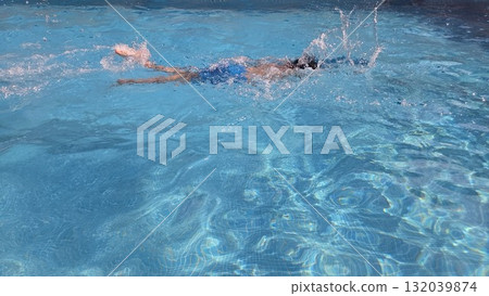 Energetic swim in refreshing pool during summer day - perfect for relaxation and fitness Energetic swim in refreshing pool during summer day - perfect for relaxation and fitness 132039874