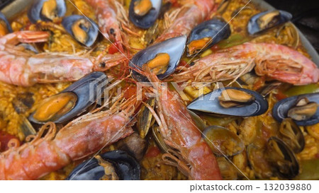 Traditional spanish paella with seafood shrimp and mussels. Close-up. Typical cuisine of Spain. Valencian cuisine. Stage of cooking paella. Ingredients for paella 132039880