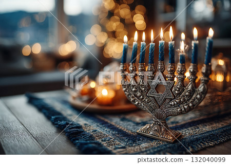 Nine candles burn in a menorah on a table. Blurred bokeh background. Hanukkah background. 132040099