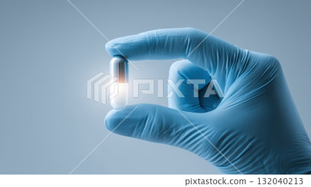 Close-Up Of Gloved Hand Holding Capsule In Medical And Healthcare Context 132040213