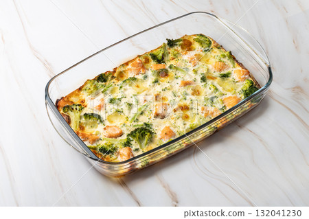 Baked salmon and broccoli casserole in glass baking dish 132041230