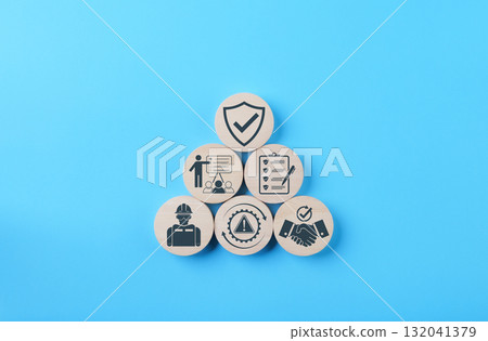 Work Safety and Compliance Risk Management Concept. Wooden blocks with icons of safety, checklist, training, handshake, compliance, risk warning, symbolizing workplace safety, risk, compliance process 132041379