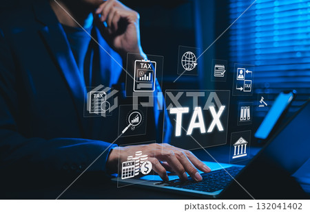 Tax Concept. Businessman using laptop for online tax planning and financial analysis with taxes icons, finance data, taxation form and IRS-related information for income reporting and calculation. 132041402
