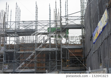 Apartment building construction site (frame scaffolding) image during framework construction Apartment building construction site (frame scaffolding) image during framework construction 132041823