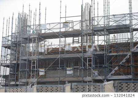 Apartment building construction site (frame scaffolding) image during framework construction 132041824