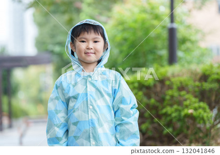 Child wearing a raincoat on a rainy day Child wearing a raincoat on a rainy day 132041846