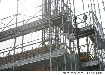 Apartment building construction site (external scaffolding) image during framework construction Apartment building construction site (external scaffolding) image during framework construction 132041894