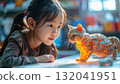 Young Asian girl captivated by a glowing 3D printed cat 132041951