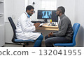 African American doctor consults patient, reviewing X-rays on computer 132041955