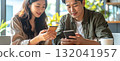 Couple enjoys coffee and smartphones at cafe 132041957